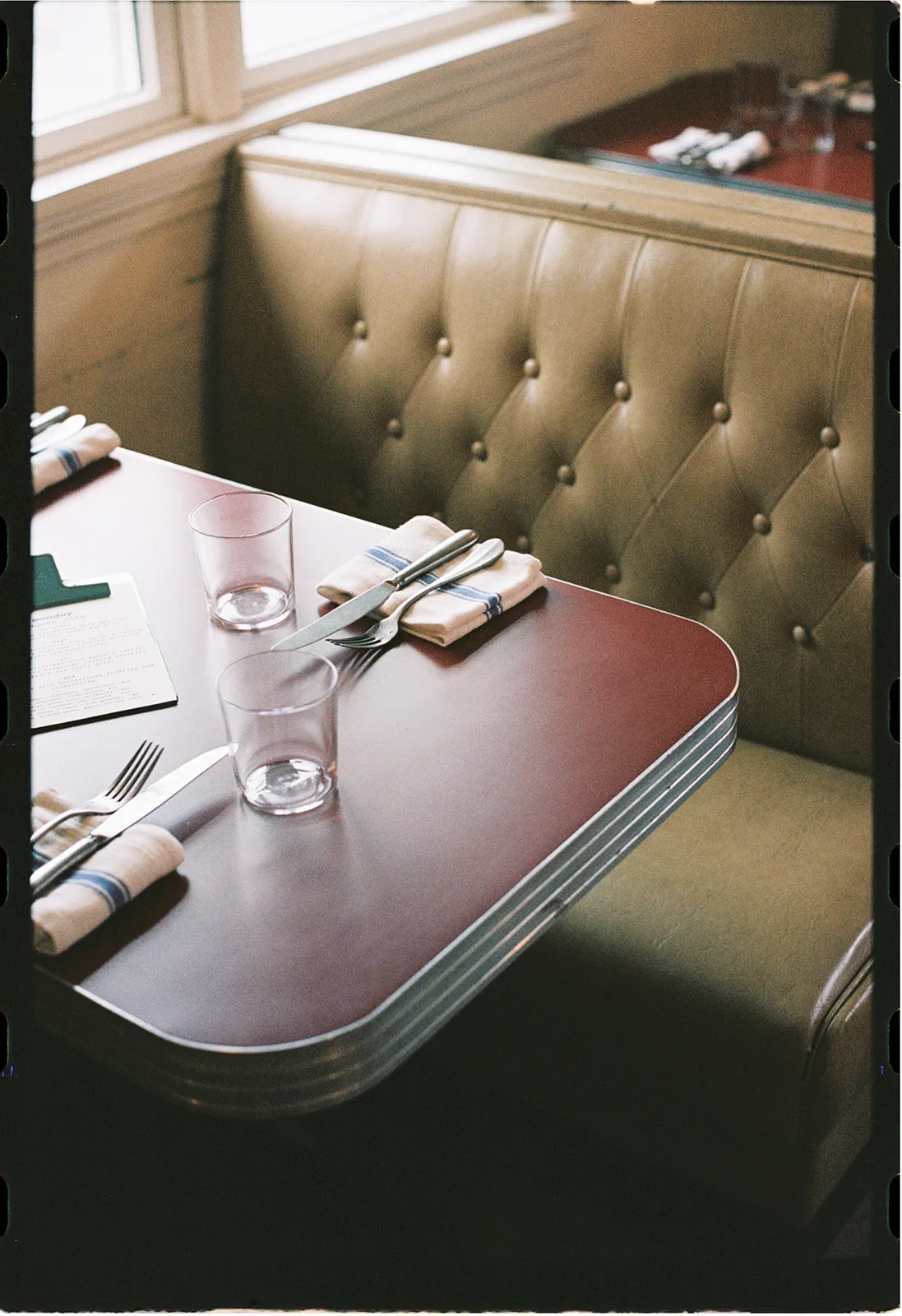 Booth seating set for dinner at the North Haven Inn diner